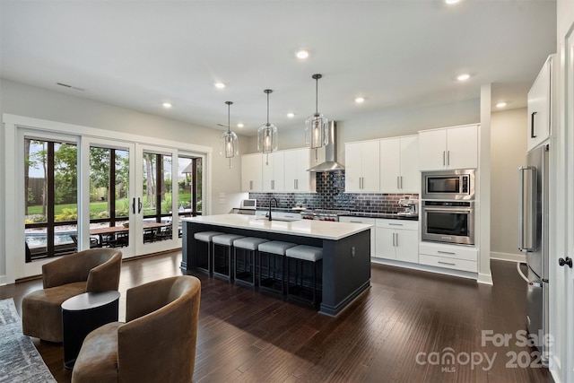 562 Preservation Dr, Fort Mill, SC 29715 - kitchen featuring appliances with stainless steel finishes, wall chimney exhaust hood, tasteful backsplash, recessed lighting, and a sink