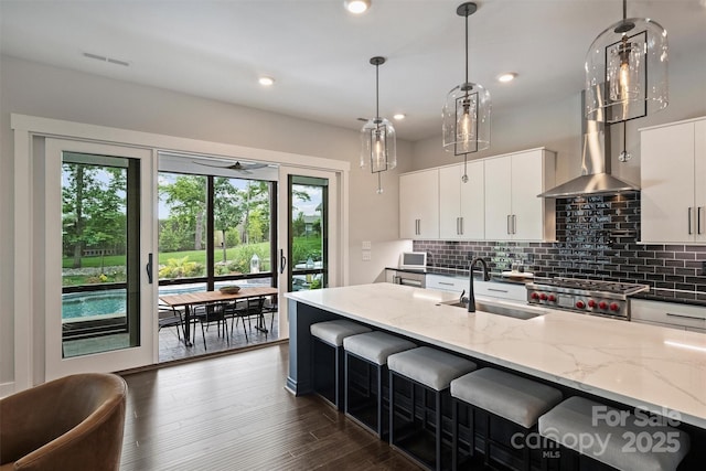 562 Preservation Dr, Fort Mill, SC 29715 - kitchen featuring a sink, plenty of natural light, decorative backsplash, light stone counters, and recessed lighting