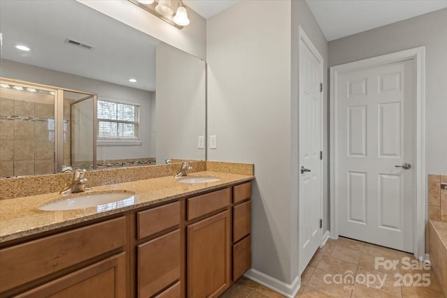 4095 Harmattan Dr, Denver, NC 28037 - full bath featuring a stall shower, tile patterned floors, double vanity, tiled tub, and baseboards