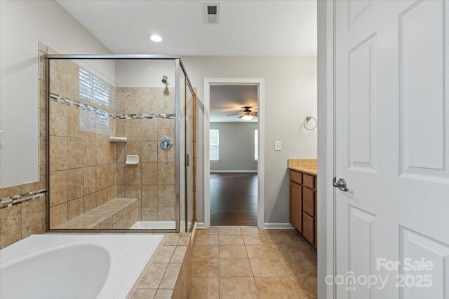 4095 Harmattan Dr, Denver, NC 28037 - bathroom featuring a stall shower, a bath, vanity, ceiling fan, and baseboards