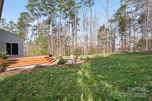 4095 Harmattan Dr, Denver, NC 28037 - view of green lawn featuring a wooden deck and an outdoor fire pit