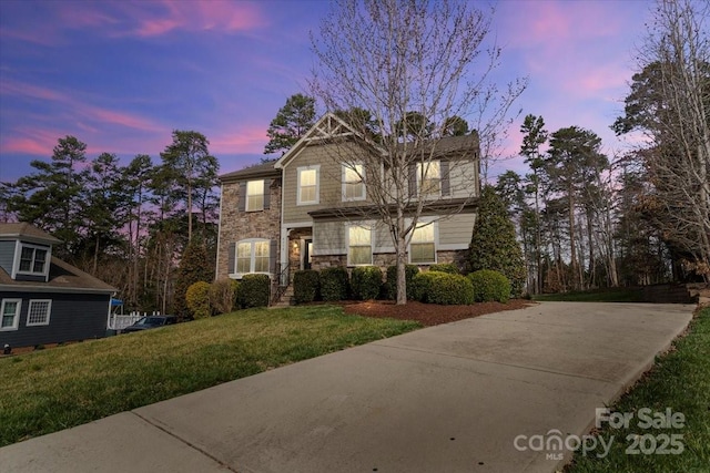 4095 Harmattan Dr, Denver, NC 28037 - traditional-style house featuring stone siding, a front yard, and concrete driveway