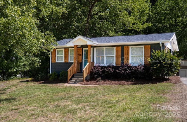 728 Morningside Dr, Mount Holly, NC 28120 - view of front of property with a front lawn, brick siding, and a shingled roof