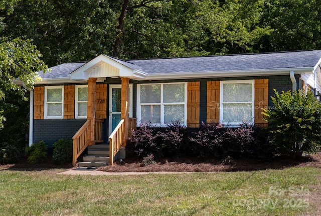 728 Morningside Dr, Mount Holly, NC 28120 - view of front of house featuring brick siding, a front lawn, and roof with shingles
