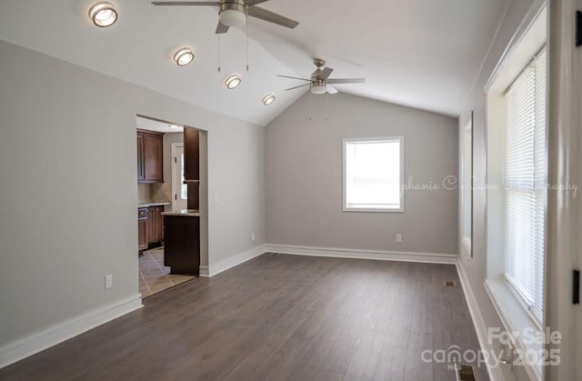 728 Morningside Dr, Mount Holly, NC 28120 - empty room with a ceiling fan, lofted ceiling, dark wood-style floors, and baseboards