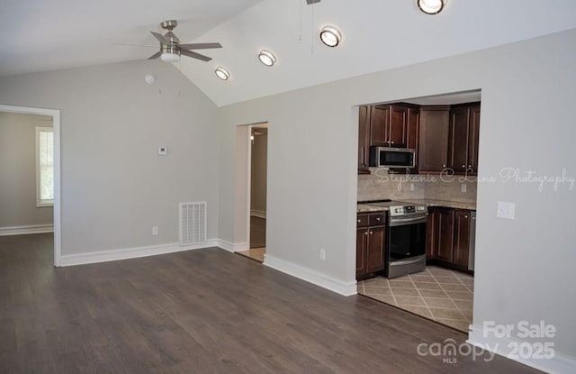 728 Morningside Dr, Mount Holly, NC 28120 - kitchen with appliances with stainless steel finishes, ceiling fan, light countertops, lofted ceiling, and decorative backsplash