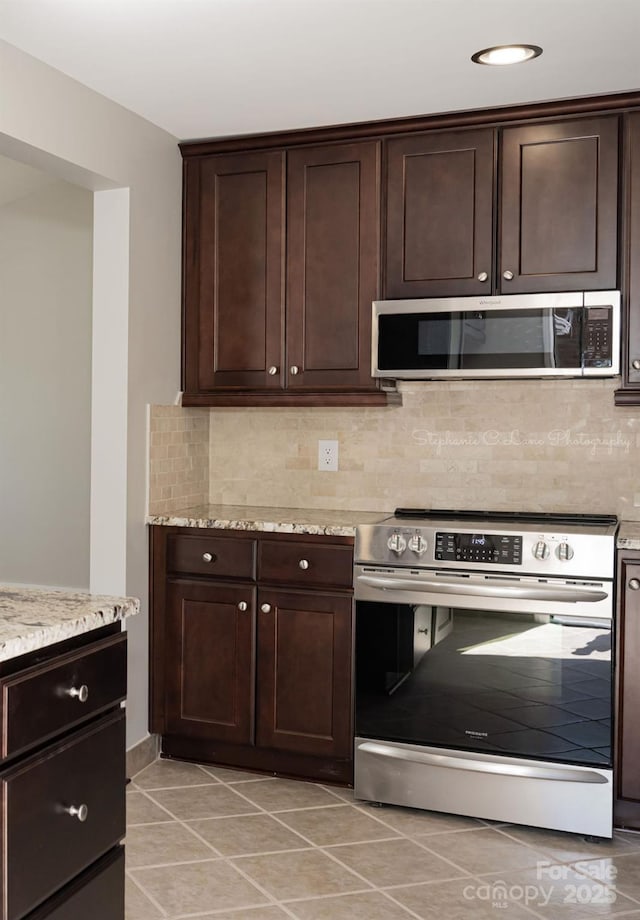 728 Morningside Dr, Mount Holly, NC 28120 - kitchen with stainless steel appliances, light tile patterned flooring, tasteful backsplash, and dark brown cabinetry
