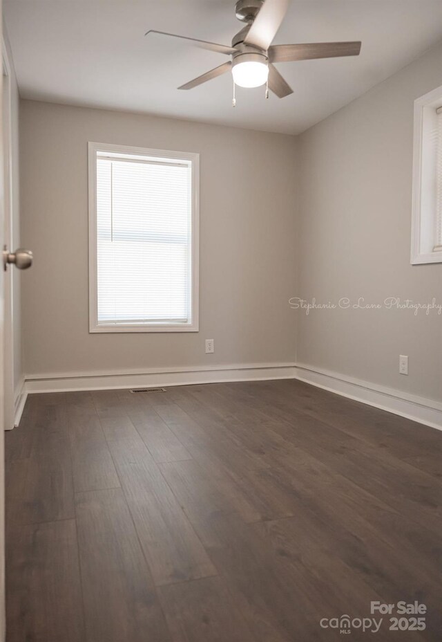 728 Morningside Dr, Mount Holly, NC 28120 - spare room with dark wood-style floors, ceiling fan, and baseboards