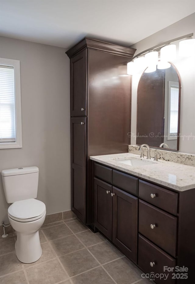 728 Morningside Dr, Mount Holly, NC 28120 - half bath featuring plenty of natural light, toilet, tile patterned flooring, and vanity