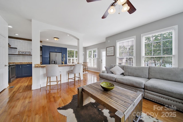 436 Third Baxter St, Fort Mill, SC 29708 - living area featuring light wood finished floors, arched walkways, a ceiling fan, and recessed lighting