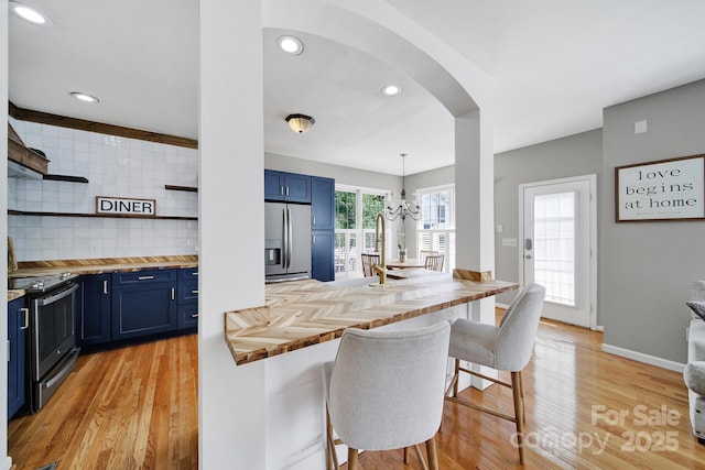 436 Third Baxter St, Fort Mill, SC 29708 - kitchen with stainless steel appliances, blue cabinets, butcher block counters, a kitchen breakfast bar, and recessed lighting