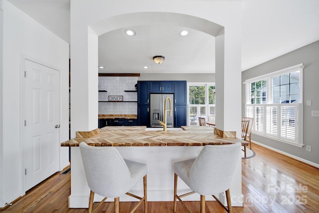 436 Third Baxter St, Fort Mill, SC 29708 - kitchen featuring blue cabinetry, butcher block counters, stainless steel fridge, arched walkways, and recessed lighting