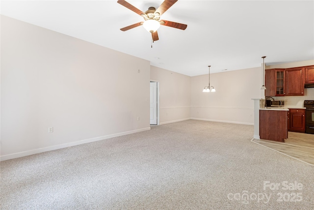 17111 Doe Valley Ct, Cornelius, NC 28031 - unfurnished living room featuring ceiling fan, a chandelier, baseboards, light carpet, and a sink