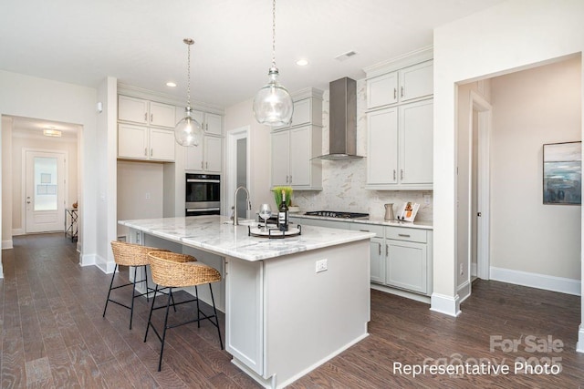 kitchen with wall chimney range hood, stainless steel gas cooktop, tasteful backsplash, baseboards, and recessed lighting