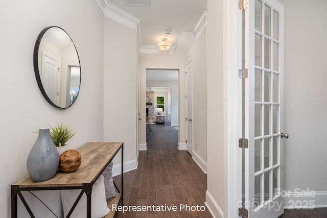 corridor with dark wood-style flooring, baseboards, and crown molding