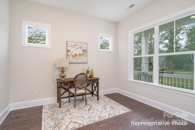 home office with dark wood-style floors and baseboards