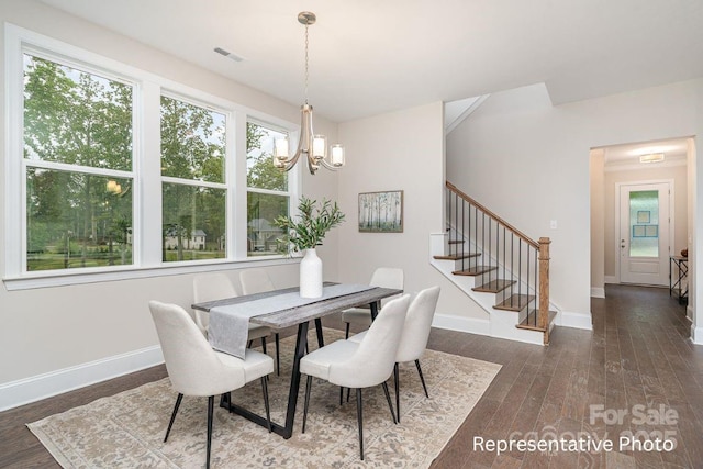 dining area featuring a chandelier, stairs, baseboards, and wood finished floors