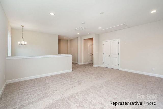 carpeted spare room featuring attic access, recessed lighting, and baseboards
