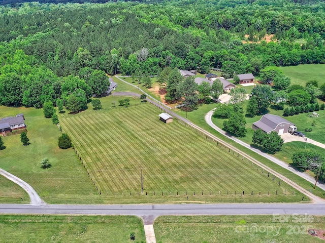aerial view of sparsely populated area featuring a forest
