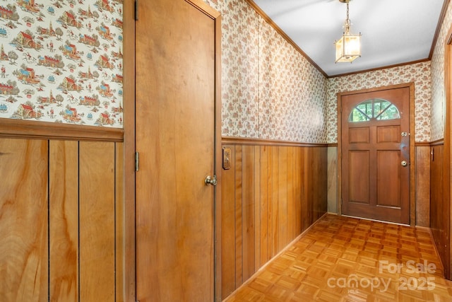 4306 Joplin Rd, Hudson, NC 28638 - doorway with wallpapered walls, a wainscoted wall, ornamental molding, and wooden walls