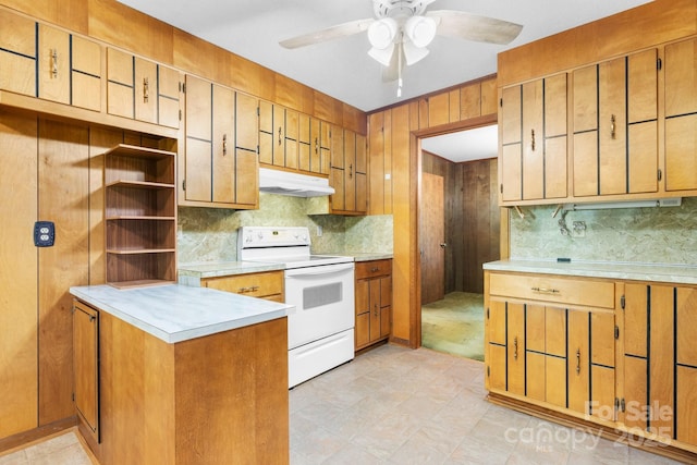 4306 Joplin Rd, Hudson, NC 28638 - kitchen with white electric range, under cabinet range hood, decorative backsplash, a ceiling fan, and wood walls