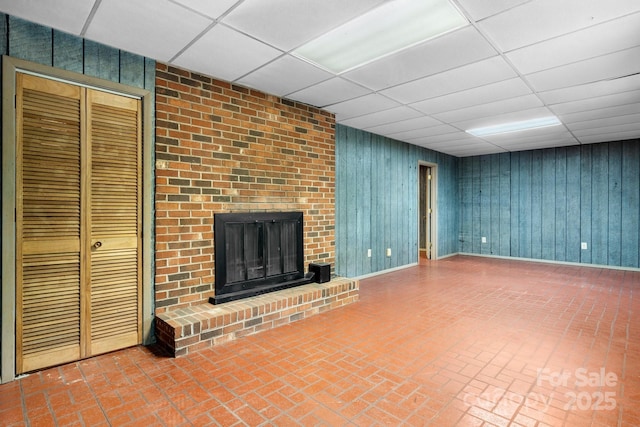 4306 Joplin Rd, Hudson, NC 28638 - unfurnished living room with a paneled ceiling, a fireplace, brick patterned flooring, and baseboards