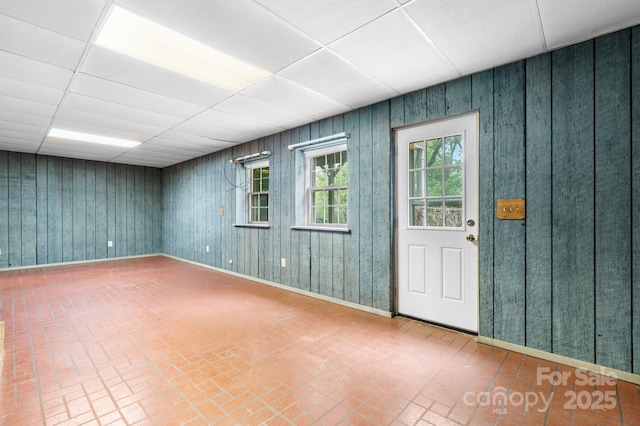 4306 Joplin Rd, Hudson, NC 28638 - spare room featuring brick patterned floors, baseboards, and a paneled ceiling