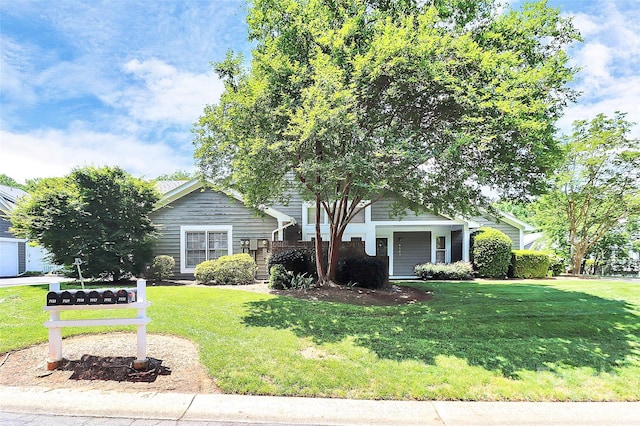 obstructed view of property featuring a front yard