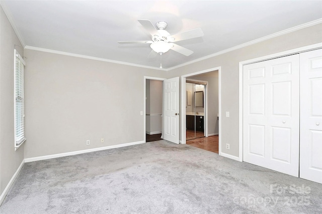 unfurnished bedroom featuring crown molding, carpet, baseboards, and a closet