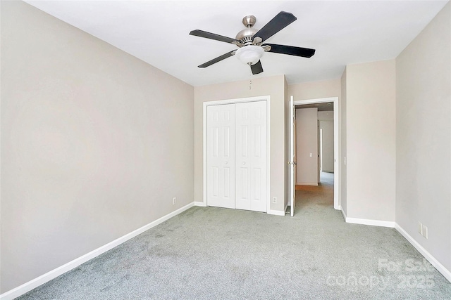 unfurnished bedroom featuring carpet, baseboards, a closet, and a ceiling fan
