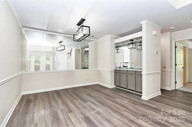 unfurnished dining area featuring wood finished floors, baseboards, and ornamental molding