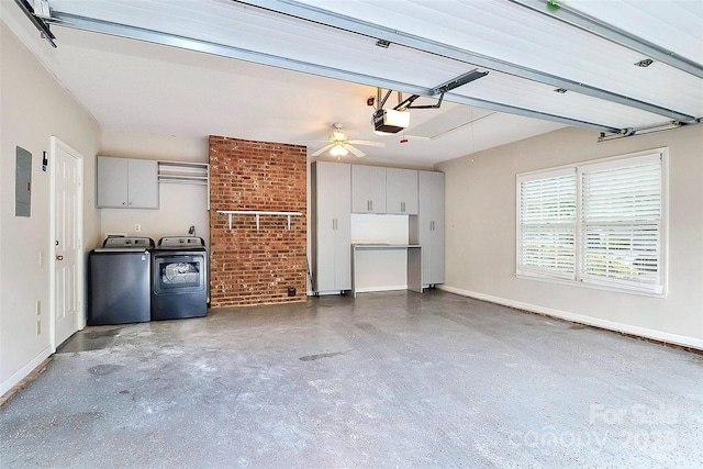 garage featuring separate washer and dryer, electric panel, a garage door opener, baseboards, and ceiling fan