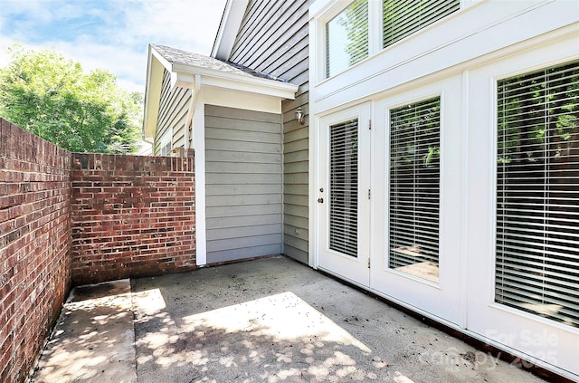 view of patio / terrace featuring french doors and fence