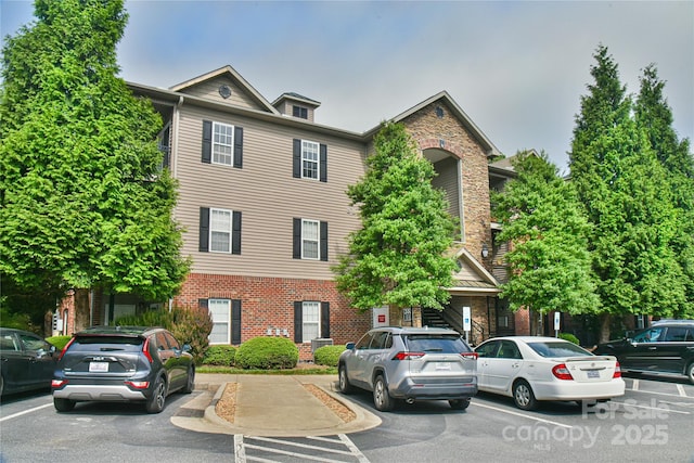 214 Appeldoorn Cir, Asheville, NC 28803 - view of property with uncovered parking and brick siding