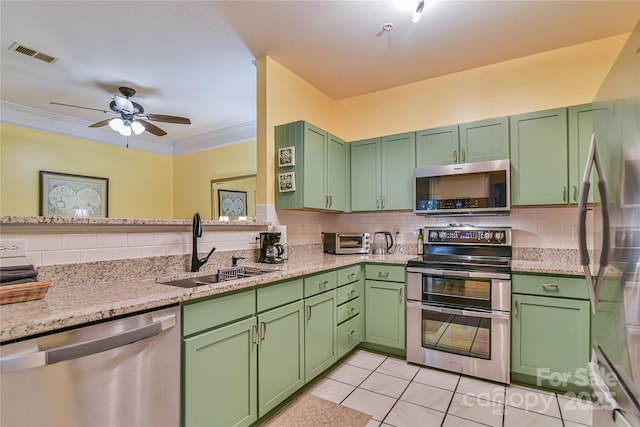 214 Appeldoorn Cir, Asheville, NC 28803 - kitchen with appliances with stainless steel finishes, a sink, decorative backsplash, ceiling fan, and crown molding