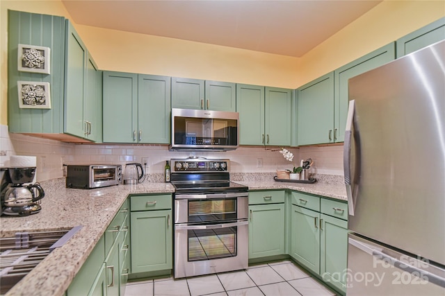 214 Appeldoorn Cir, Asheville, NC 28803 - kitchen featuring stainless steel appliances, tasteful backsplash, light tile patterned floors, and green cabinetry
