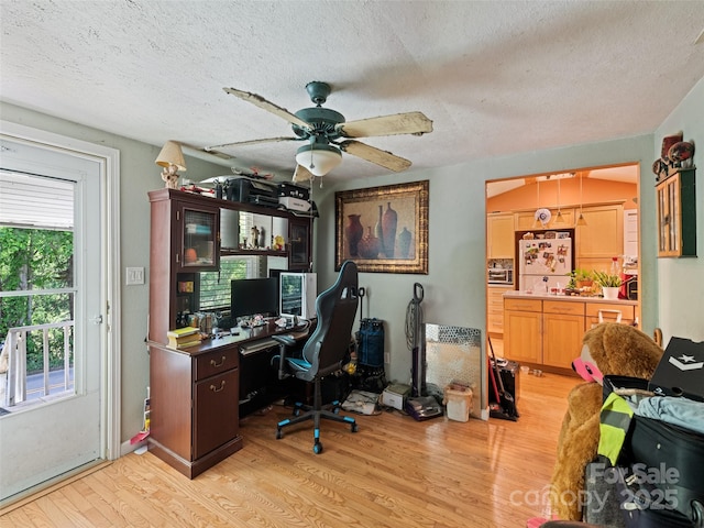 3407 Thickety Rd, Clyde, NC 28721 - home office featuring light wood-type flooring, ceiling fan, and a textured ceiling