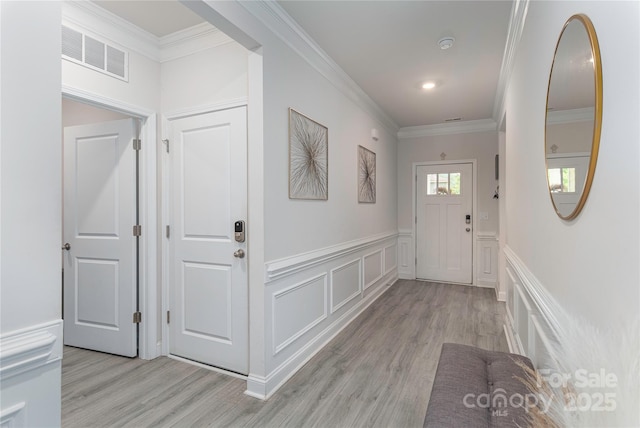 70 Rose Creek Rd, Leicester, NC 28748 - entryway featuring light wood-style floors, a decorative wall, wainscoting, and ornamental molding