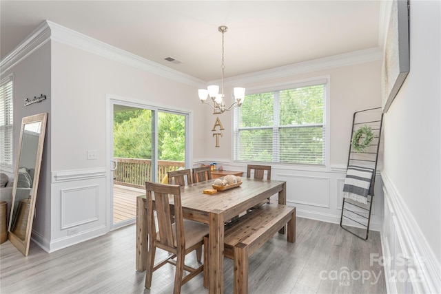 70 Rose Creek Rd, Leicester, NC 28748 - dining room with ornamental molding, light wood-style floors, a decorative wall, a wainscoted wall, and a chandelier
