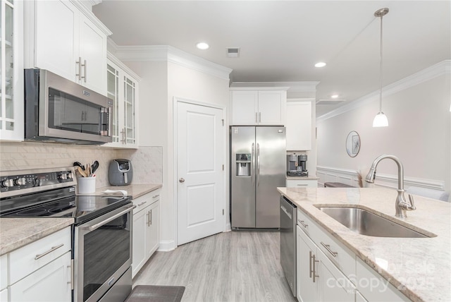 70 Rose Creek Rd, Leicester, NC 28748 - kitchen featuring stainless steel appliances, a sink, ornamental molding, white cabinets, and glass insert cabinets