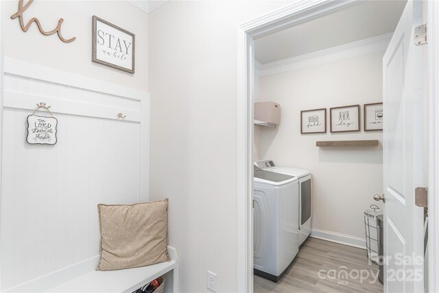 70 Rose Creek Rd, Leicester, NC 28748 - laundry room with crown molding, light wood-style floors, separate washer and dryer, and baseboards