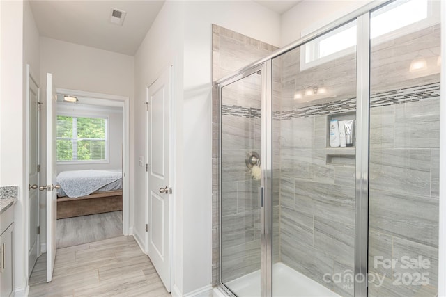 70 Rose Creek Rd, Leicester, NC 28748 - full bathroom with a shower stall, vanity, ensuite bath, wood finished floors, and baseboards