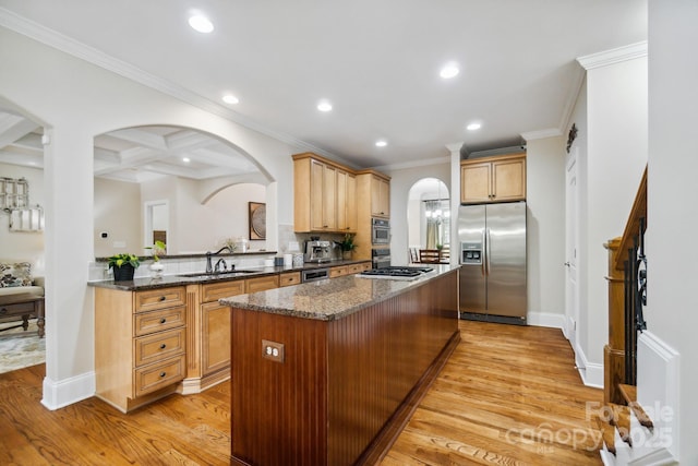 6795 Montgomery Rd, Lake Wylie, SC 29710 - kitchen featuring appliances with stainless steel finishes, a sink, arched walkways, a center island, and light wood-style floors