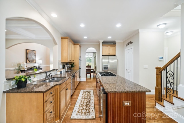 6795 Montgomery Rd, Lake Wylie, SC 29710 - kitchen with appliances with stainless steel finishes, a sink, light wood-style floors, a center island, and arched walkways