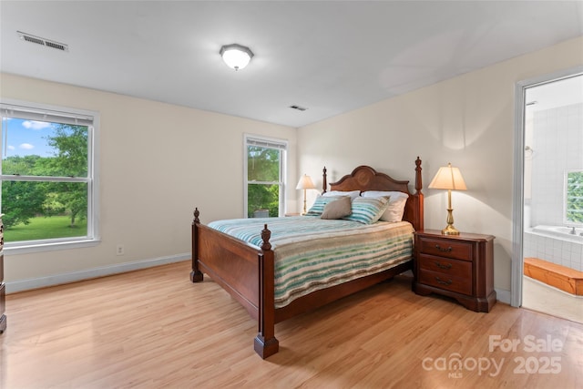 2315 Lanesboro Rd, Marshville, NC 28103 - bedroom featuring light wood-type flooring, baseboards, and ensuite bathroom