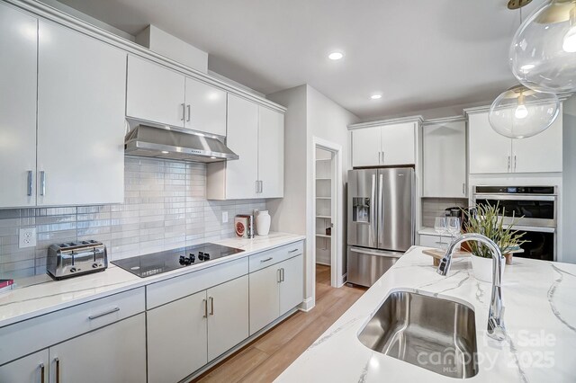 7513 Lancaster Hwy Unit 6, Waxhaw, NC 28173 - kitchen with stainless steel refrigerator with ice dispenser, black electric stovetop, a sink, under cabinet range hood, and light wood-style flooring