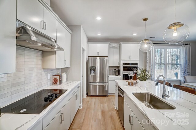 7513 Lancaster Hwy Unit 6, Waxhaw, NC 28173 - kitchen with stainless steel appliances, under cabinet range hood, a sink, backsplash, and hanging light fixtures