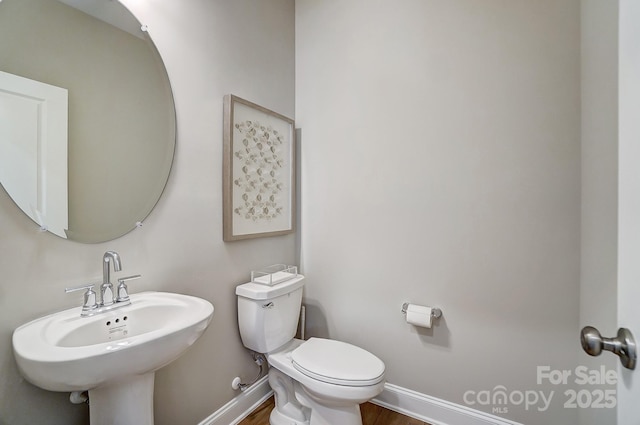 7513 Lancaster Hwy Unit 6, Waxhaw, NC 28173 - bathroom with baseboards, toilet, wood finished floors, and a sink