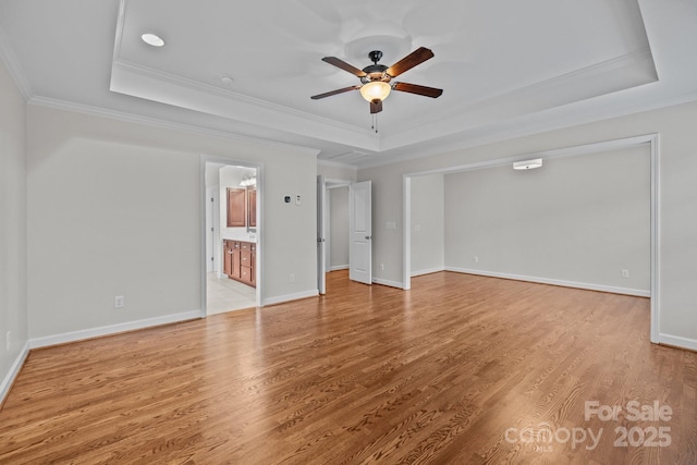 3206 Lakehurst Xing, Matthews, NC 28104 - unfurnished bedroom with a raised ceiling, ornamental molding, light wood-type flooring, baseboards, and connected bathroom