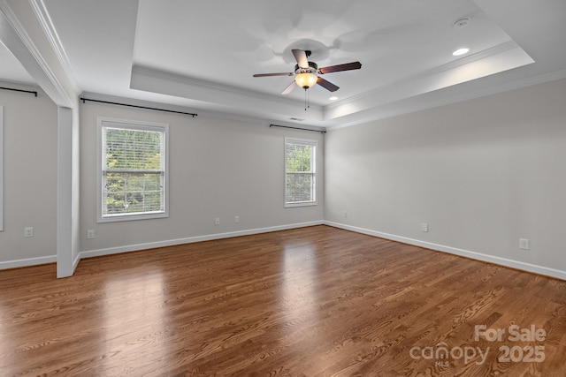 3206 Lakehurst Xing, Matthews, NC 28104 - empty room with a raised ceiling, healthy amount of natural light, crown molding, a ceiling fan, and wood finished floors